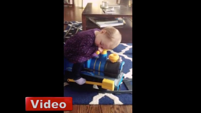 Oyuncak trenin üstünde uyuya kalan çocuk